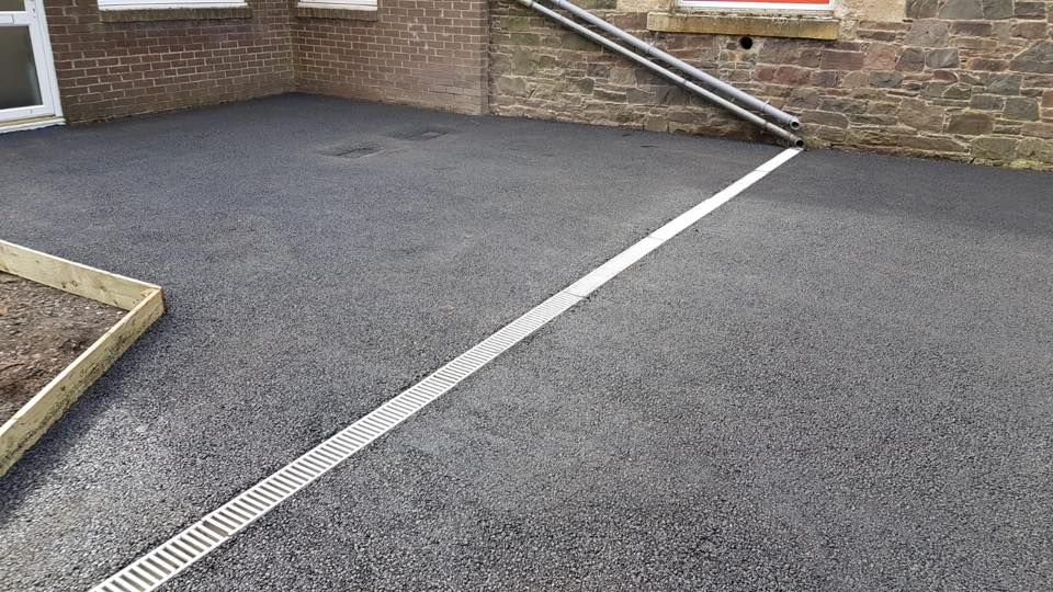 new tarmac parking area with aqua channel drainage timber edging